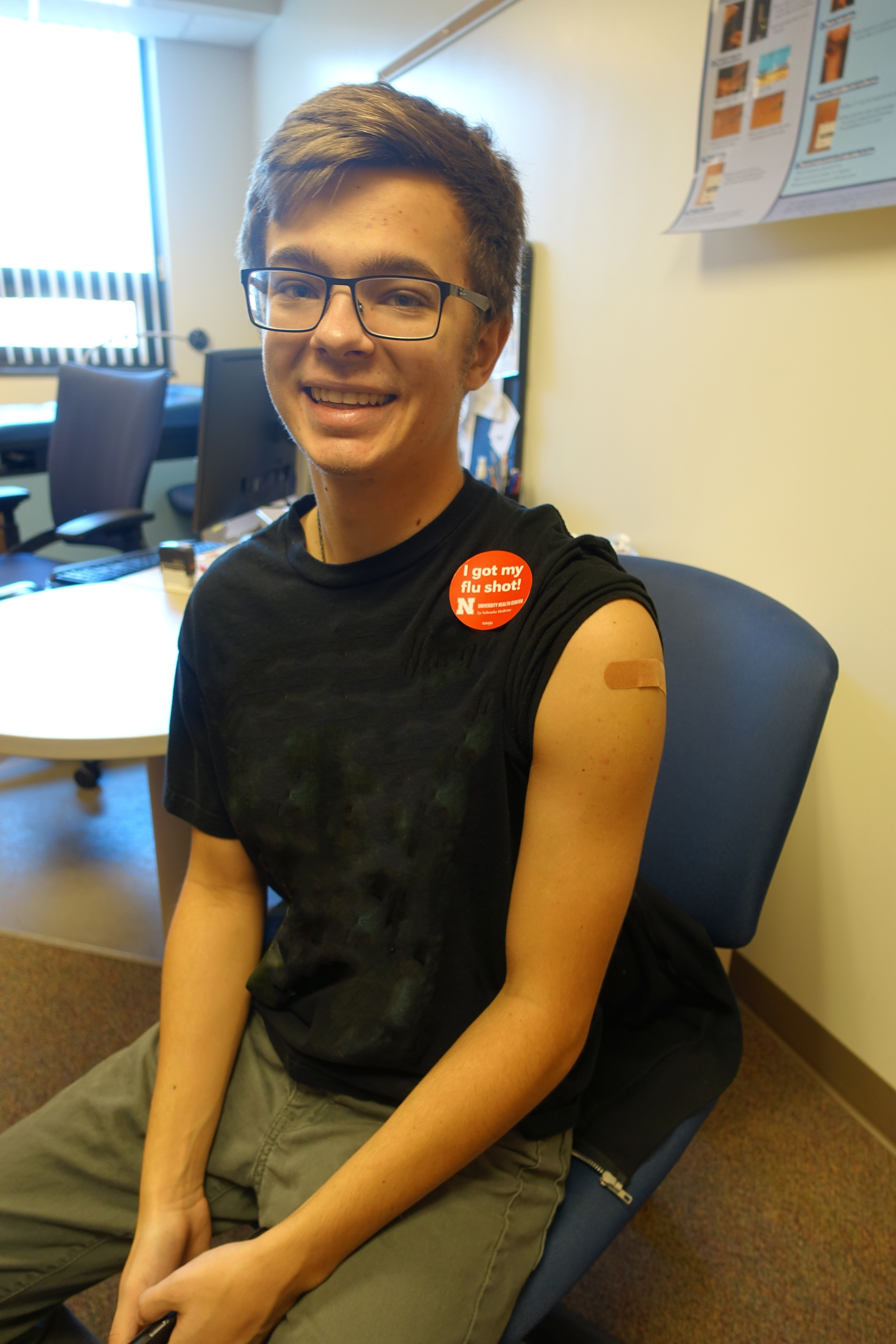 A Nebraska student proudly displays a sticker to show they got a flu shot.