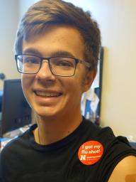 Student wears sticker showing they obtained a flu shot.