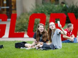 Huskers (from left) Miranda Mueller and Miranda Hornung take a selfie while enjoying their lunches during the Aug. 31 “In Our Grit, Our Glory” celebration on East Campus. | University Communication