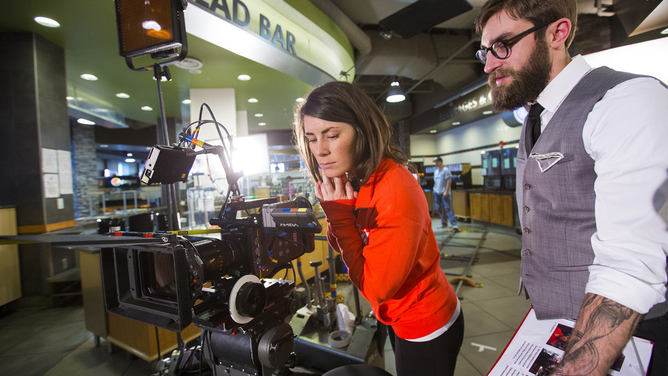 Nebraska's Amanda Christi and Andrew Swenson film a recruitment video in the Abel-Sandoz Dining Center. The admissions duo also led Nebraska's production of the "In Our Grit, Our Glory" institutional spot. Photo by Craig Chandler, University Communication