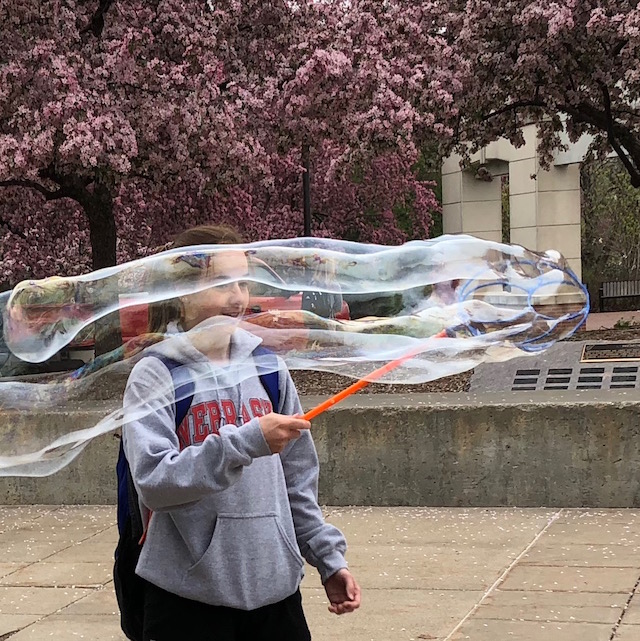 Blowing bubbles on the Nebraska Union Plaza