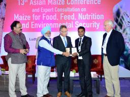 Dinesh Panday (second from right) is presented the 2018 Maize-Asia Youth Innovator Award by (from left) Dr. B.M. Prasanna, Director of the Consultative Group on International Research Program on Maize (CGIAR MAIZE); Dr. Martin Kropff (right), Director Gen