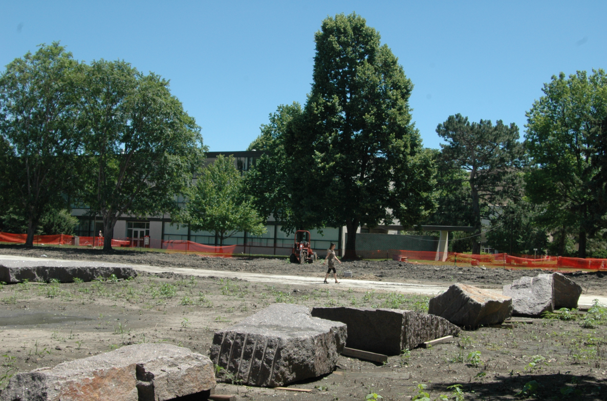 The green space honoring University Hall is located between Woods Hall (in the background) and Manter Hall.