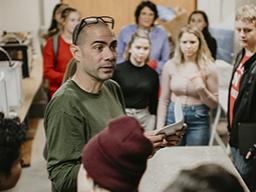 Associate Professor of Art Santiago Cal discusses the sculpture program with students from Lincoln Public Schools. Photo by Justin Mohling.