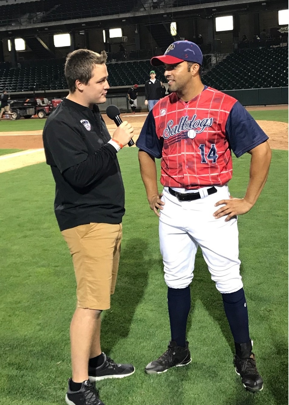 Ryan Schreurs (left) interviews Randolph Oduber, a Salt Dogs baseball player, during Schreurs’ internship in summer 2018.