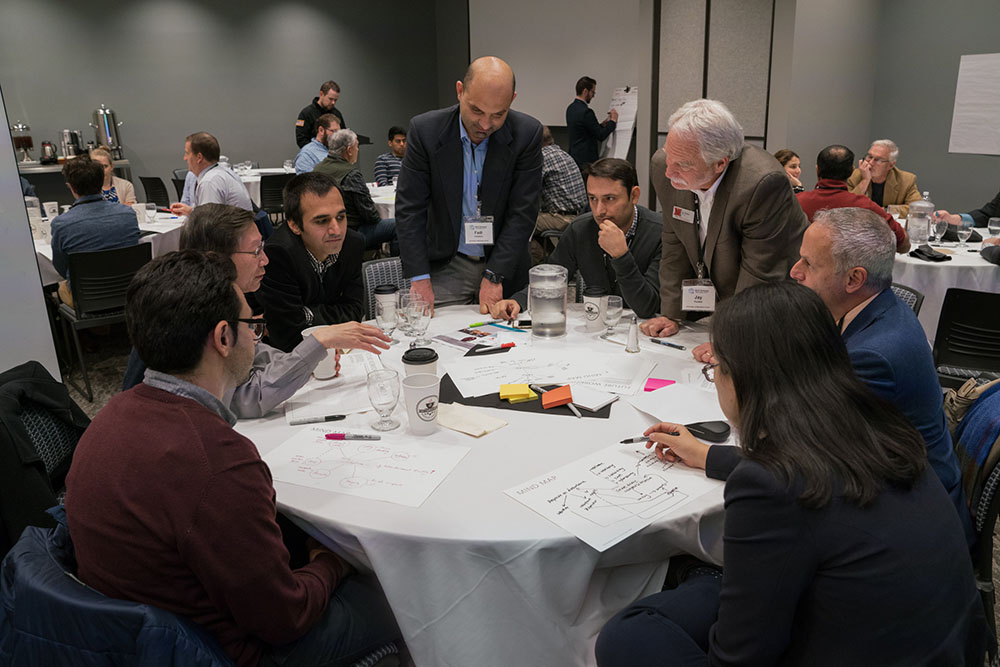 Fadi Alsaleem (standing left), assistant professor of architectural engineering, and Jay Puckett, director of The Durham School of Architectural Engineering and Construction, lead a discussion during the afternoon session Nov. 9 at the Smart Building and 