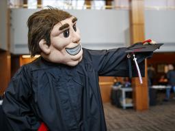 Herbie Husker gets fitted with a commencement gown during Nebraska Gradfest in late November at the Wick Alumni Center. The university's December commencement exercises are Dec. 14 and 15 at Pinnacle Bank Arena. |  Craig Chandler, University Communication