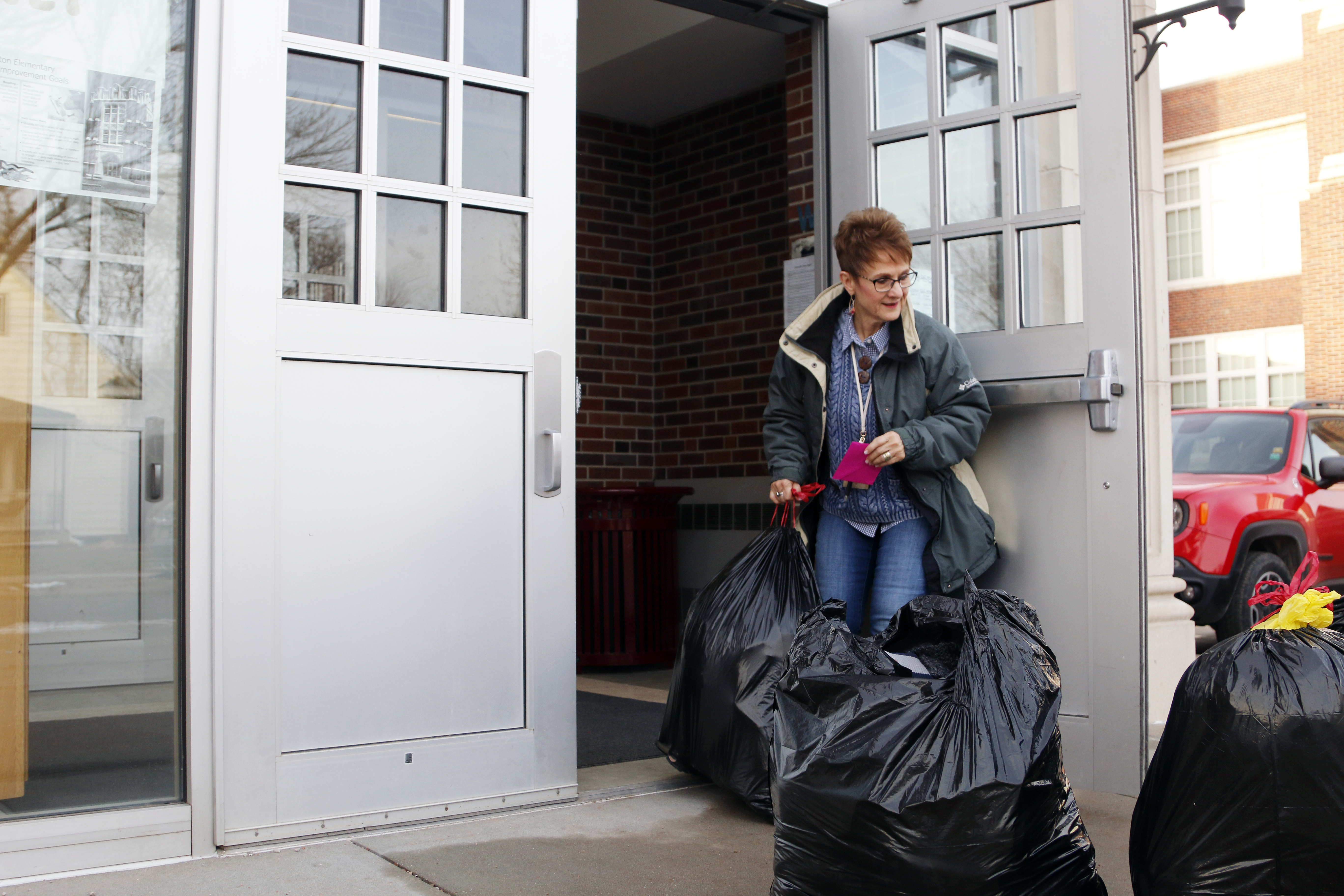Linda Kern, of Clinton Elementary School, helps bring in the donations from the SNR Caring for Clinton Drive on Tuesday, Dec. 11, at the school on 29th and Holdrege streets. | Shawna Richter-Ryerson, Natural Resources
