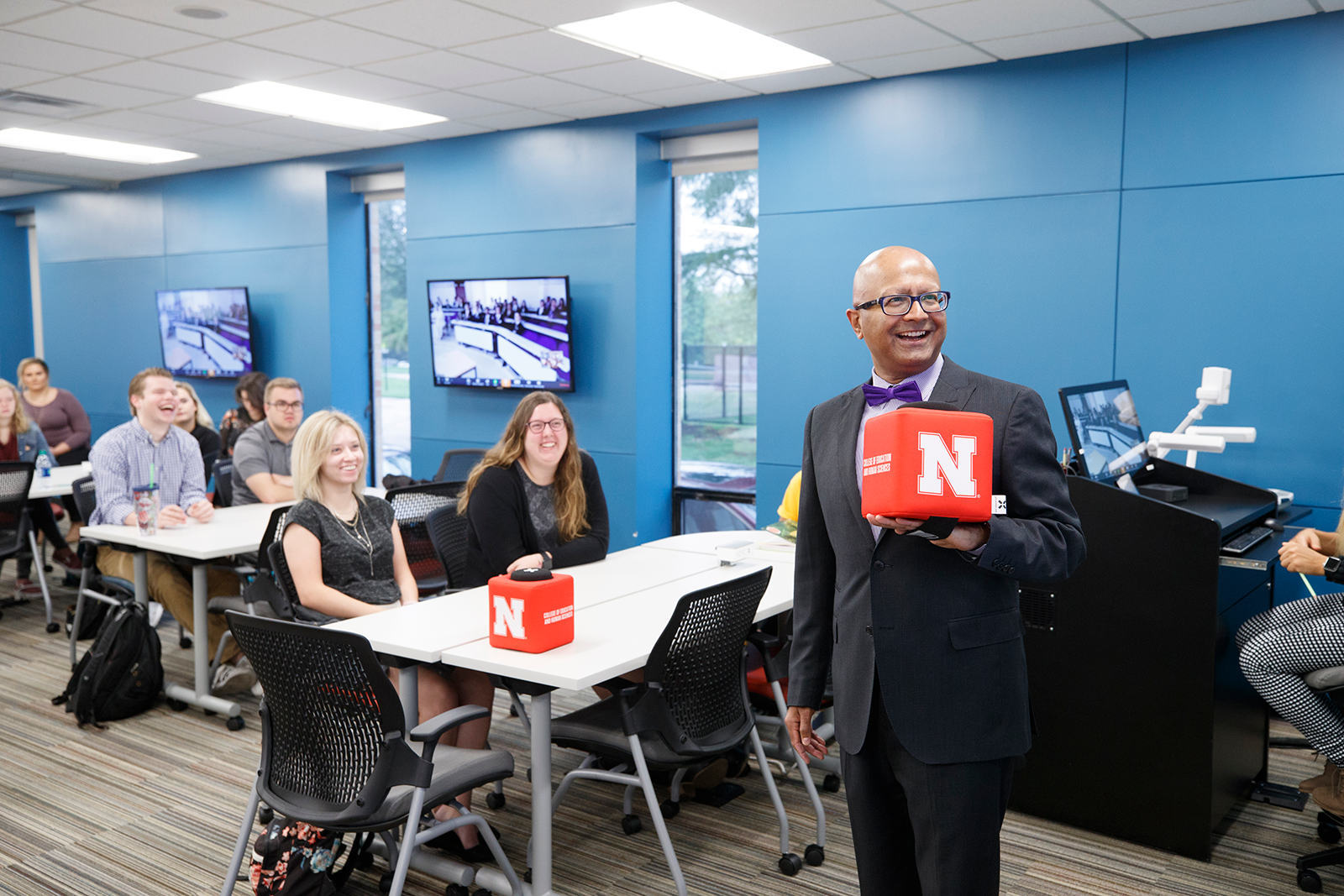 Dipra Jha and students in his virtual exchange class share a laugh with peers from The Emirates Academy in Dubai, United Arab Emirates. (Photo credit: Craig Chandler / University Communications)