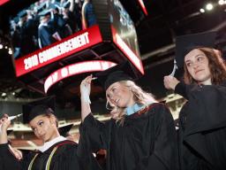 Virginia Hill (left), Master of Arts in political science; Hillary Hotz (center), Master of Arts in educational administration; and Melissa LaRosa (right), Master of Arts in educational psychology; move their tassels at the end of the graduate and profess