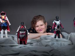Stephanie Pitcher is pictured with avatars from her thesis project, inspired by games such as "Assassin's Creed" and "Final Fantasy."  Greg Nathan | University Communication 