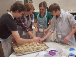 Anna Sump and three other delegates baking bread as part of a workshop. The bread was then donated to the Atlanta Community Food Bank.