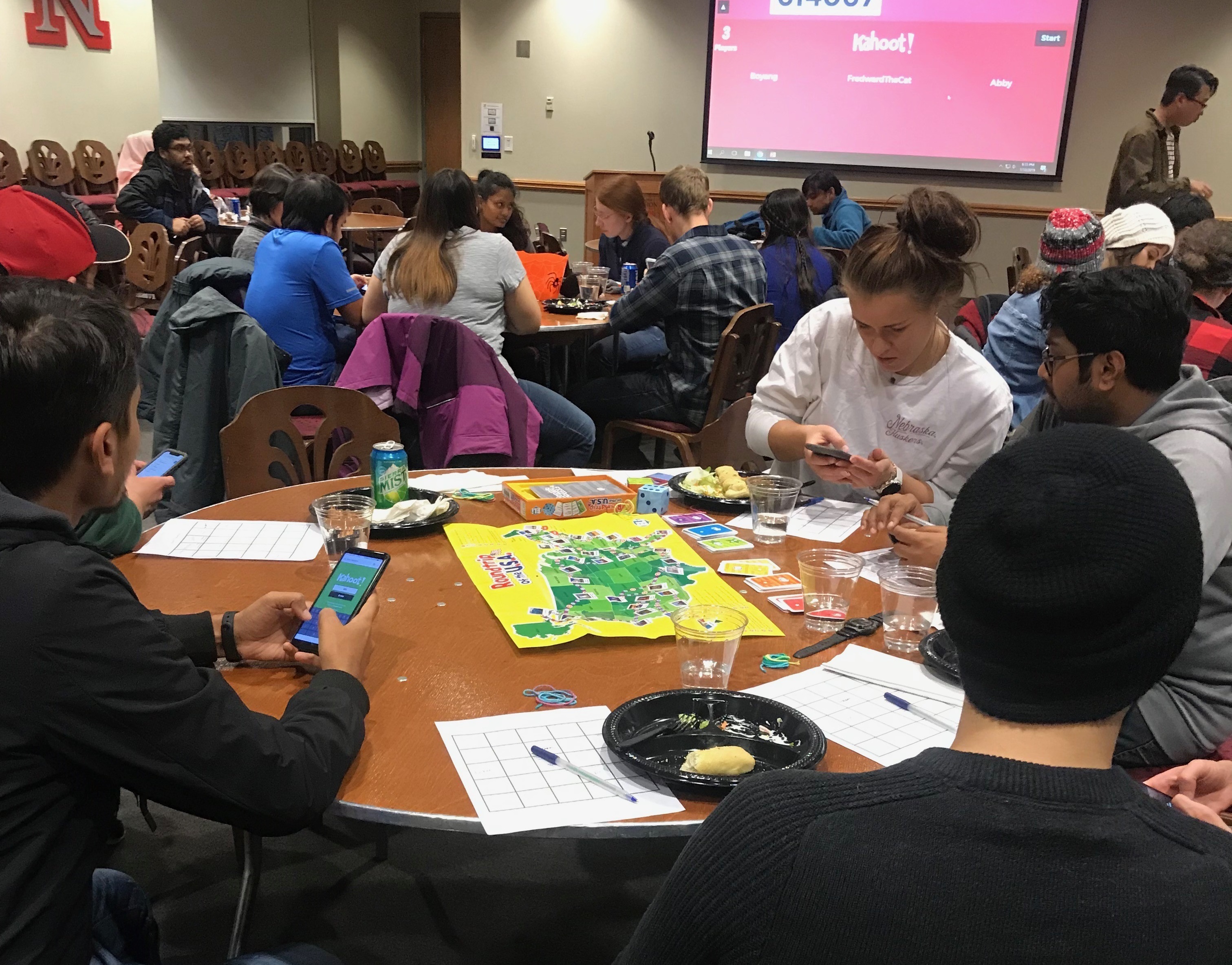 Students at the spring 2019 international graduate student welcome party play the trivia game Kahoot! to answer questions about Nebraska and countries around the world.