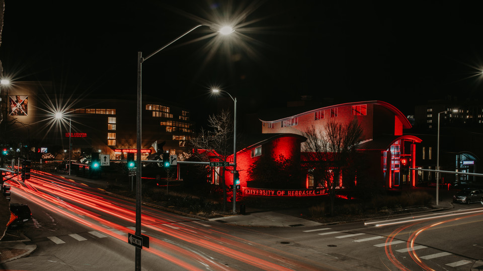 The Van Brunt Visitors Center on City Campus is illuminated in red light. PC: Justin Mohling, University Communications.