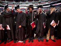 Students turn their tassels to signify their official graduation during the All-University Commencement at Pinnacle Bank Arena on August 16, 2014. Photo by Morgan Spiehs for University Communications Photography.