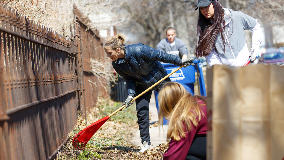Huskers rake help rake leaves in a Lincoln neighborhood during the 2018 Big Event. The annual community service event, which is part of a national program, will be held April 6. Registration is open through March 8. | Craig Chandler, University Communicat