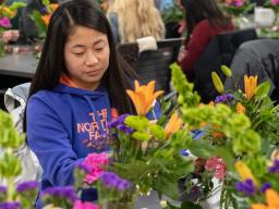 A student completes a spray during the Floral Design class Feb. 26.