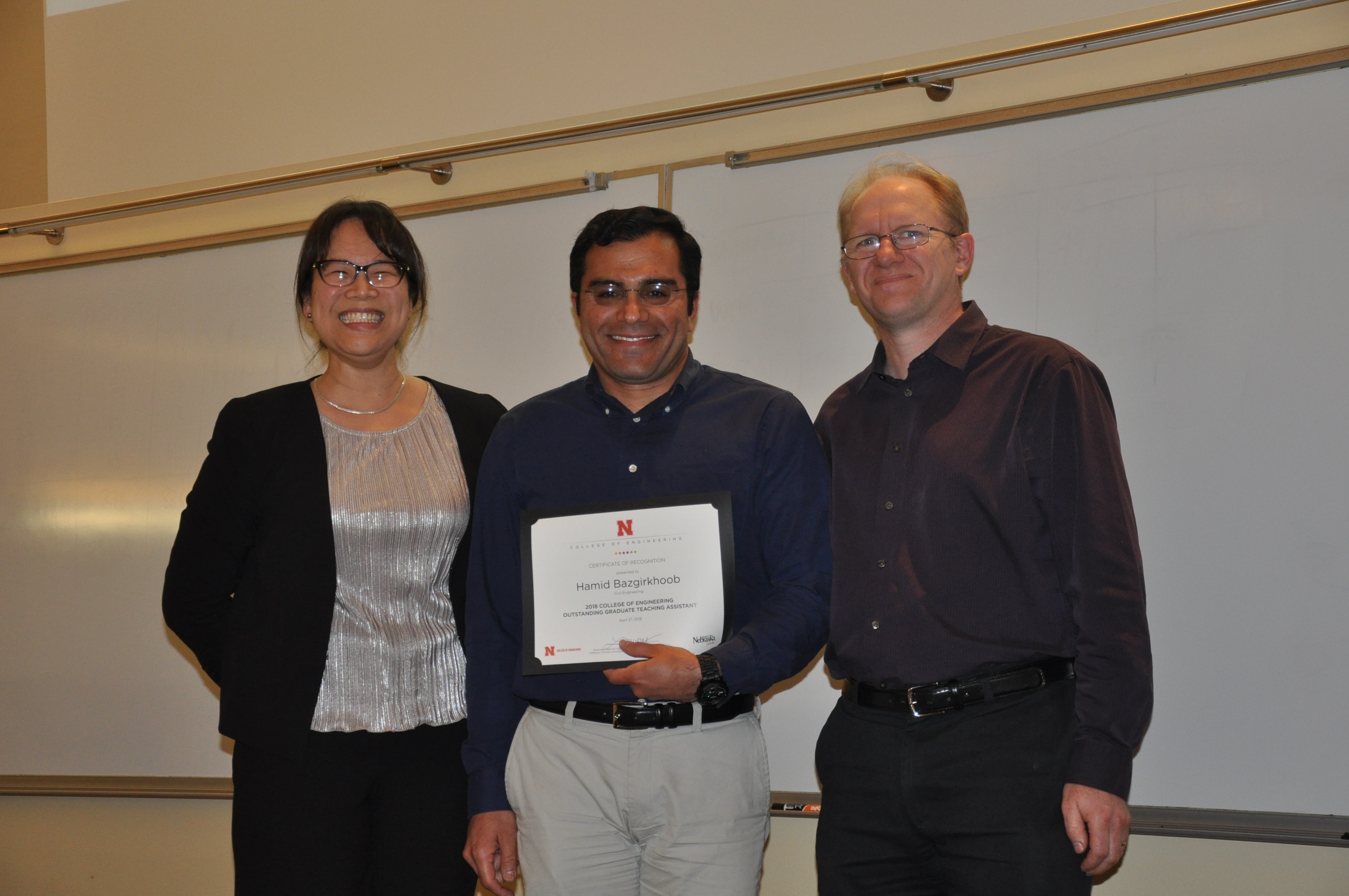 Hamid Bazgirkhoob (center) was chosen as the 2018 Outstanding Graduate Teaching Assistant. His award was presented by Lily Wang (left) and David Admiraal. 