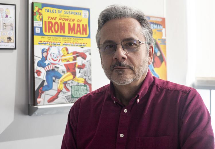 Dan Claes poses for a portrait with his comic memorabilia in his office in Jorgensen Hall on Thursday, Feb. 28, 2019, in Lincoln, Nebraska. Photo by Jackson Wilford 