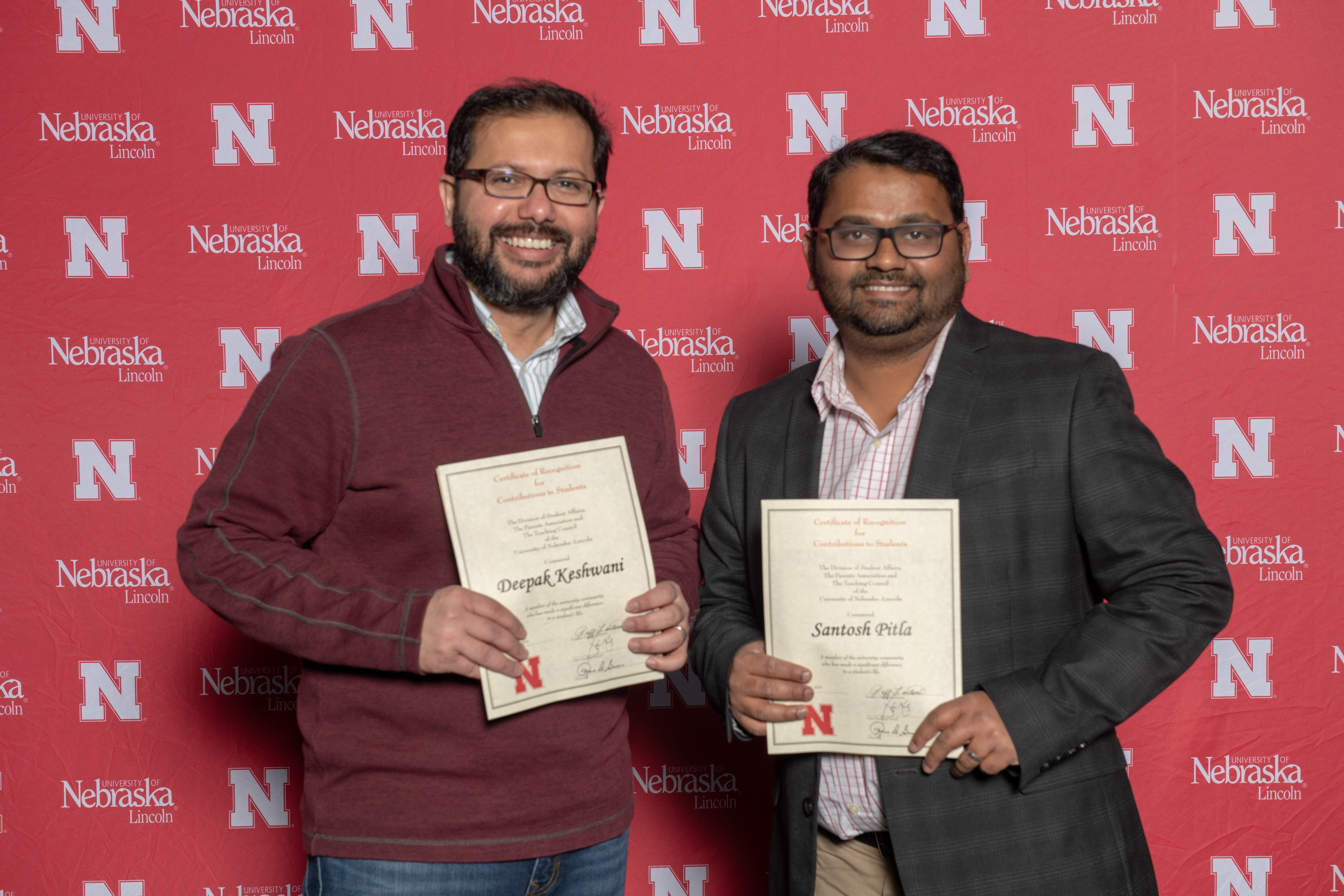 Associate Professor of Biological Systems Engineering, Deepak Keshwani, and Assistant Professor, Advanced Machinery Systems, Santosh Pitla smile with their awards at the annual Parents' Recognition Award Ceremony. Photo by Greg Nathan.