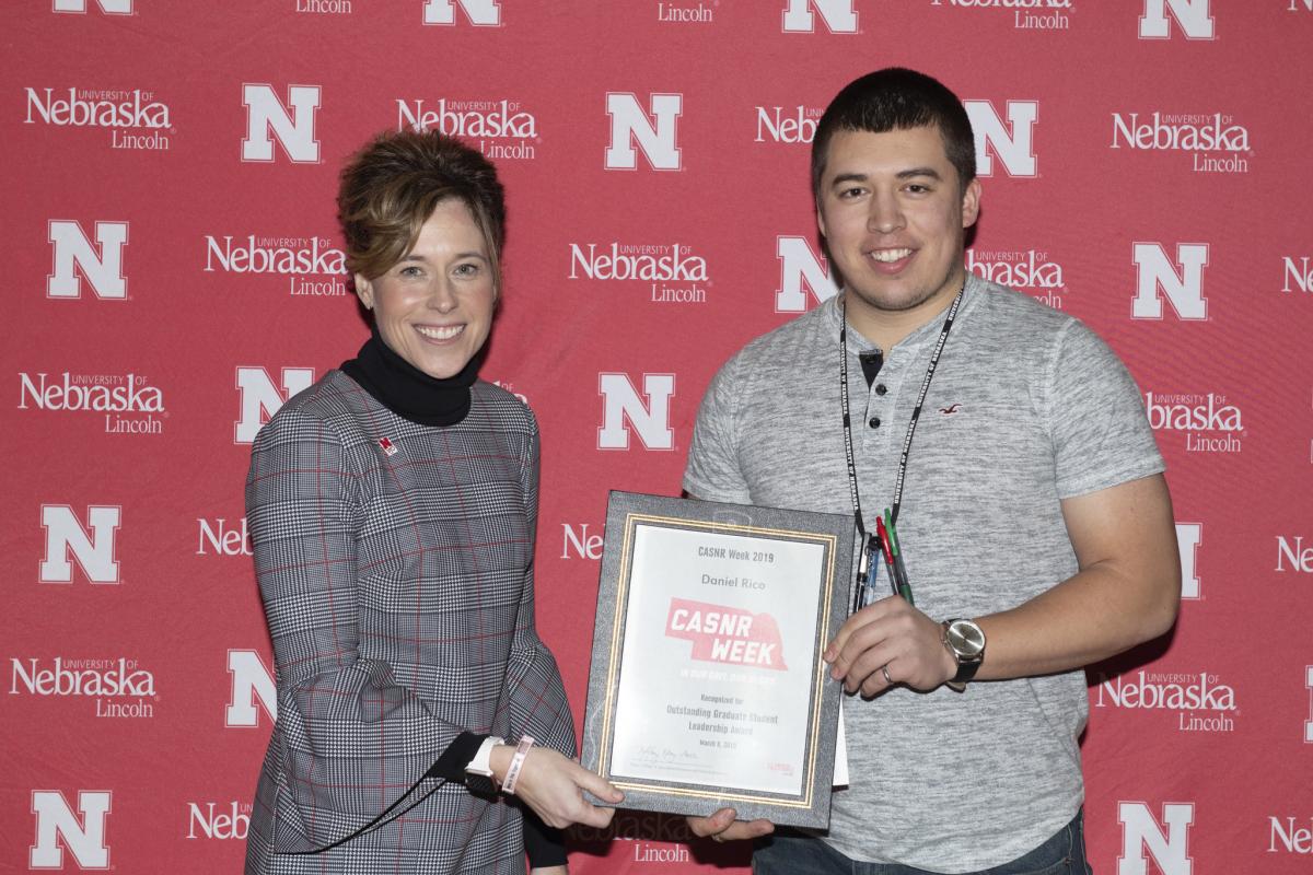 Daniel Rico receives the Outstanding Graduate Student Award from Tiffany Heng-Moss, dean of the College of Agricultural Sciences and Natural Resources, at the CASNR awards luncheon on March 8, 2019.