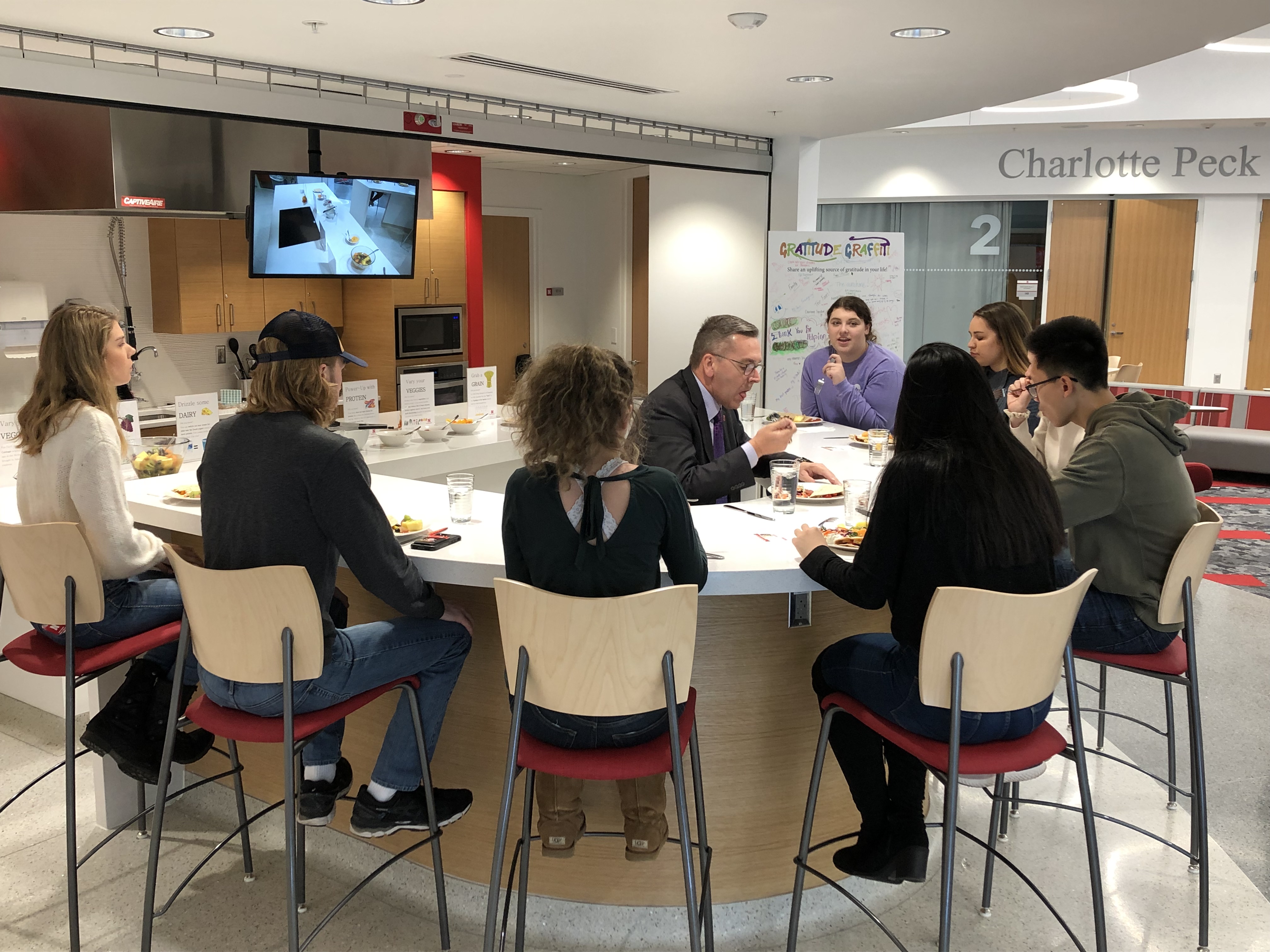 Well-being coaches join Chancellor Green for lunch in the Wellness Kitchen.