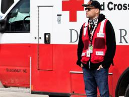 Journalism student Kenneth Ferriera interviews Red Cross Disaster Services volunteer Joel Olavarrio outside a shelter in Fremont. 