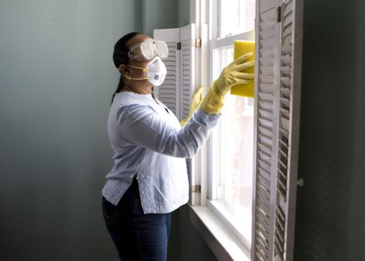 woman cleaning window