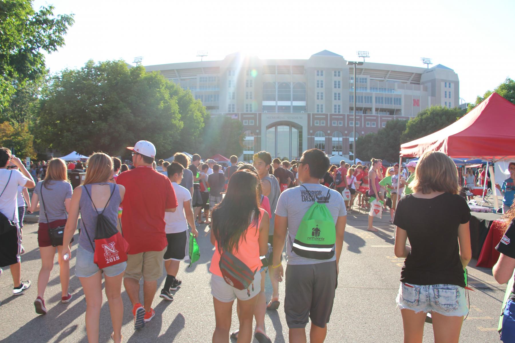 Students walk the Memorial Stadium Loop at the Big Red Welcome Street Festival.