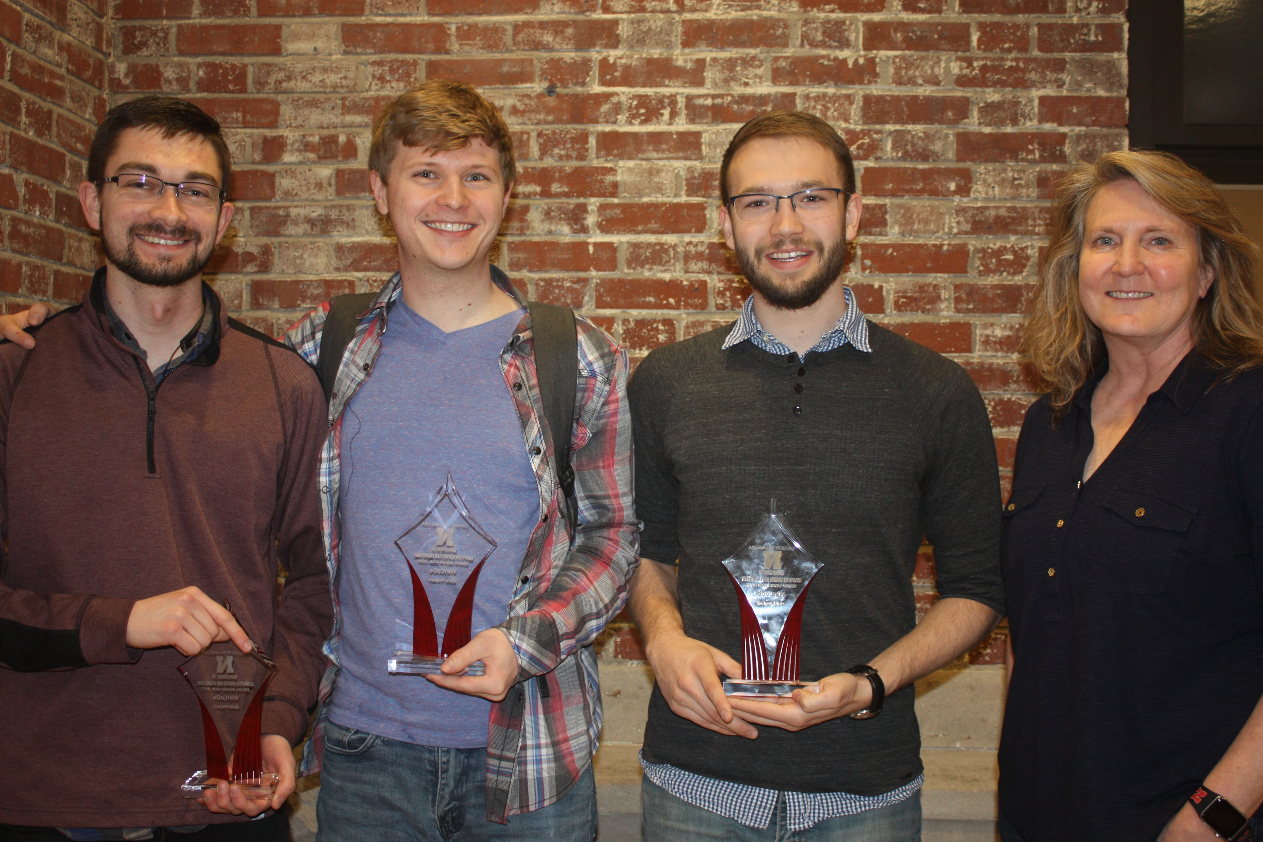 Gold Award team members Tyler Barker, Alex Enersen, and Colton Harper with project manager Melanie Kugler-Wright.