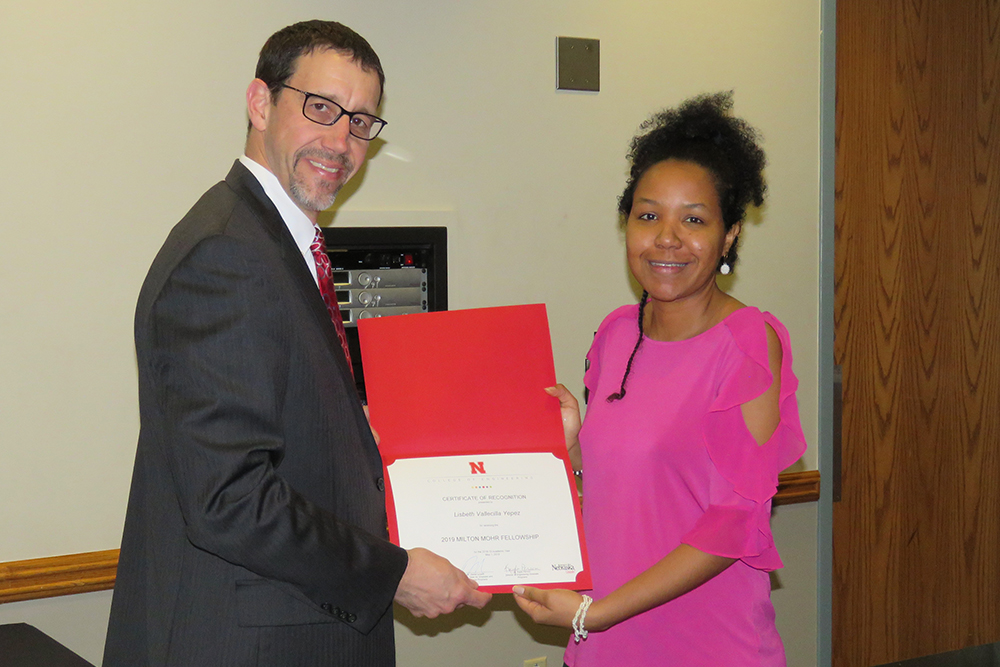 Lisbeth Vallecilla Yepez is honored with a Milton E. Mohr Fellowship by Dan Linzell, associate dean for graduate and international programs.