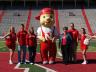 The Berka family strikes a pose with Lil' Red and Husker cheerleaders during their 2010 Parents Week visit.