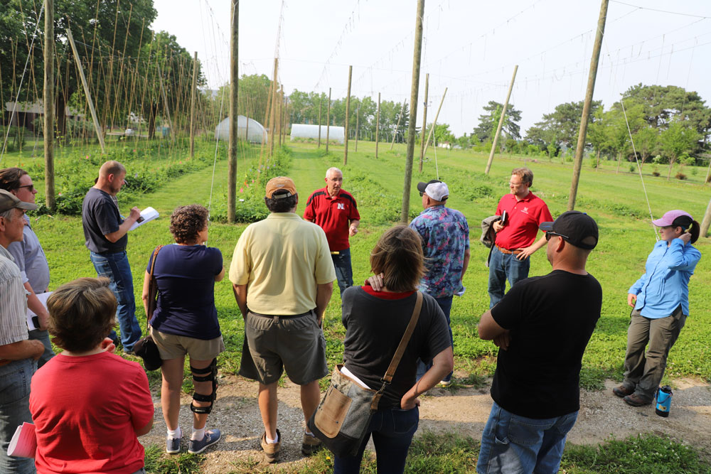 Stacy Adams, Keenan Amundsen and Allison Butterfield speak to hop workshop participants at the University of Nebraska–Lincoln East Campus hop yard May 31.