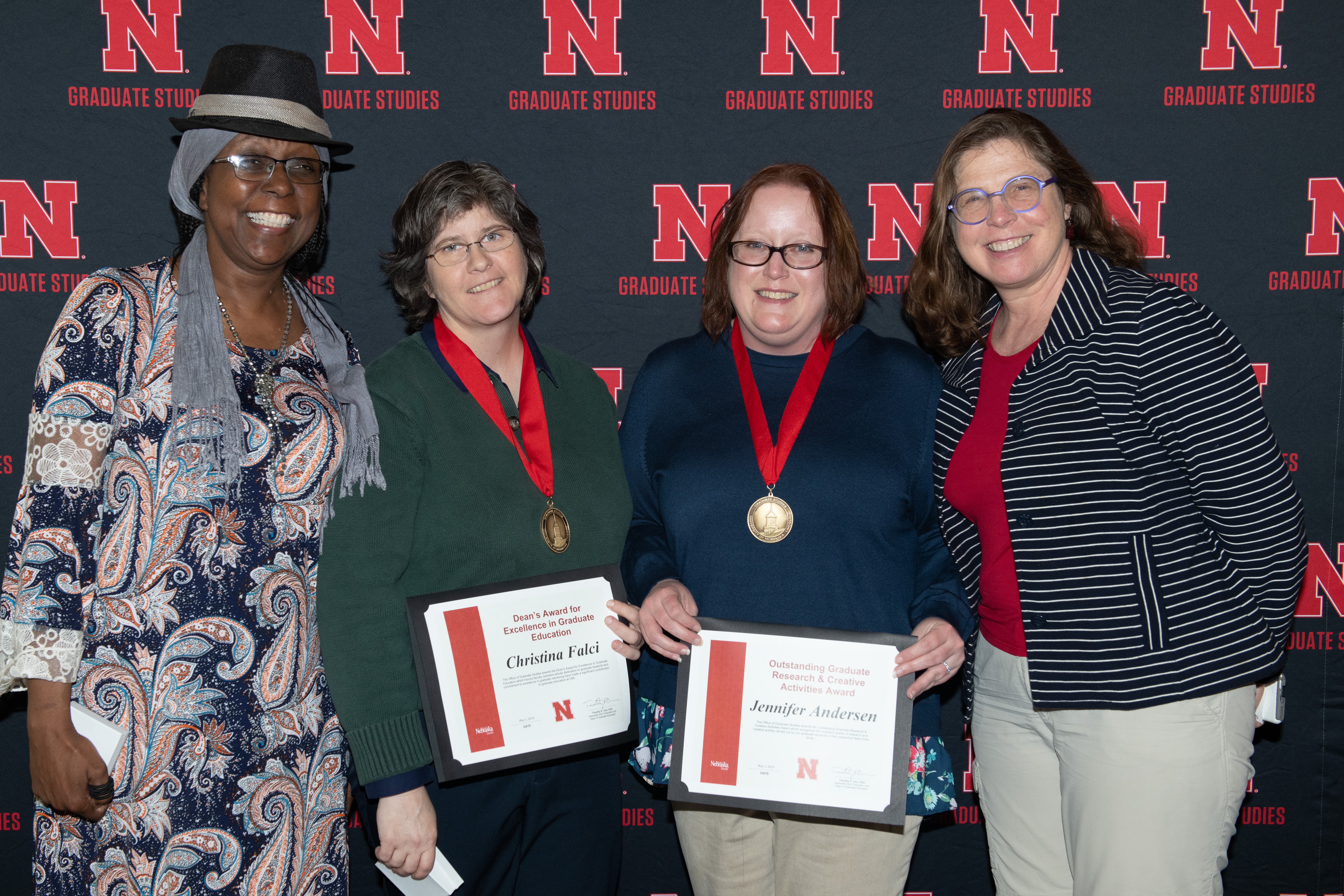 Lory Dance, Christina Falci, graduate student Jennifer Andersen, and Julia McQuillan celebrate awards won by Falci and Andersen at a ceremony earlier this year. 