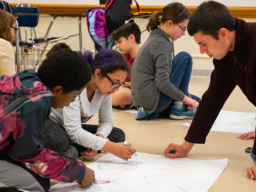 Luke Novak works with children as part of  Dr. Julia McQuillan's research on science knowledge/interest among middle schoolers.