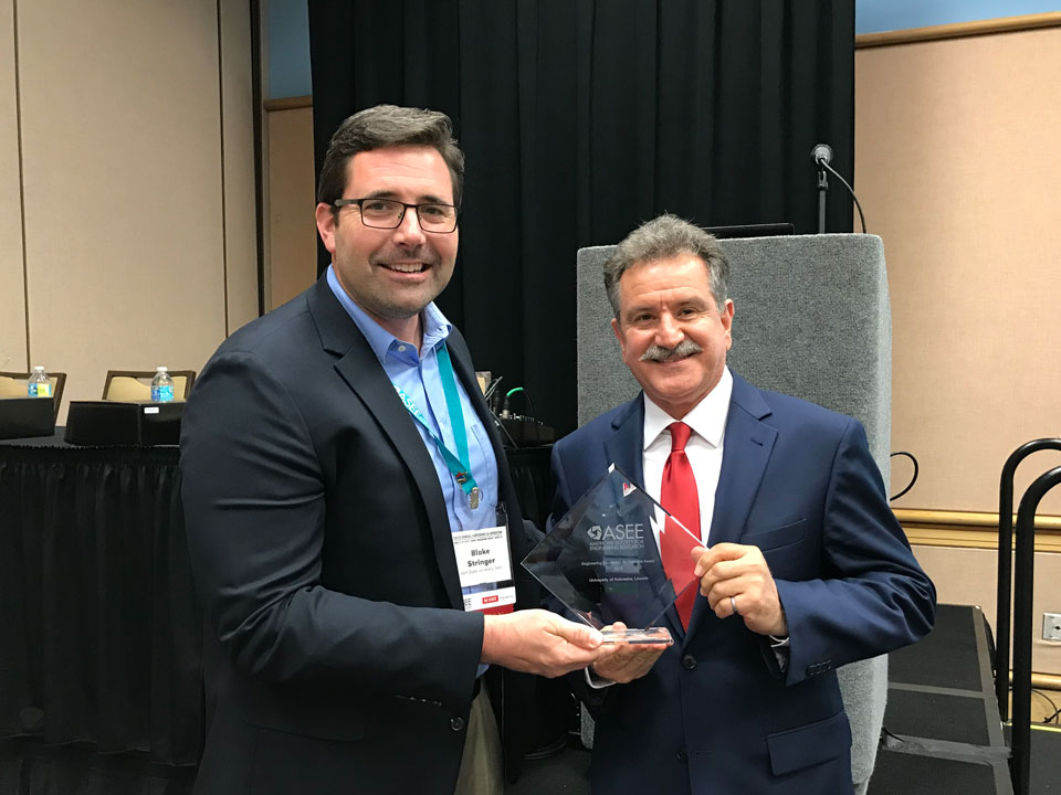Sohrab Asgarpoor (right), associate dean for undergraduate programs, accepted the ASEE Excellence in Engineering for Veterans Award for the College of Engineering.