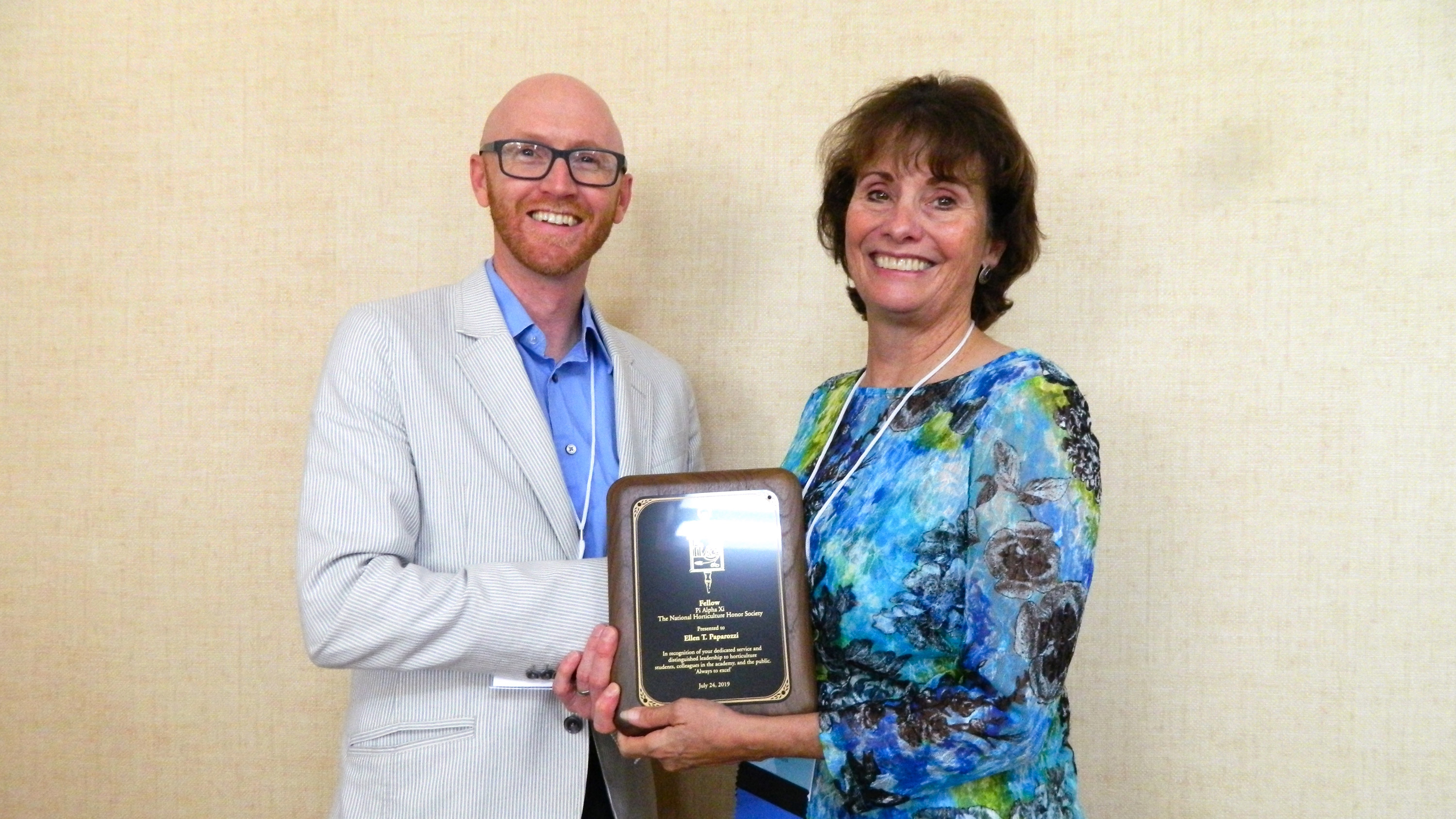 Ellen Paparrozi, right, accepts the Pi Alpha Xi Fellow award from Ryan Contreras, President of Pi Alpha Xi National.