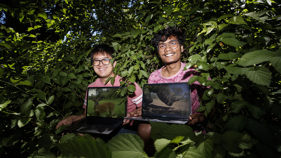  Brian Chong, left, and Rahul Prajapati, right, are using deep learning technology to automatically identify, count and track the behavior of animals in trail camera images. | Craig Chandler, University Communication