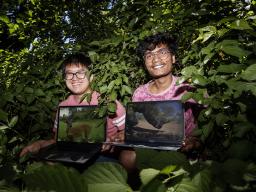  Brian Chong, left, and Rahul Prajapati, right, are using deep learning technology to automatically identify, count and track the behavior of animals in trail camera images. | Craig Chandler, University Communication