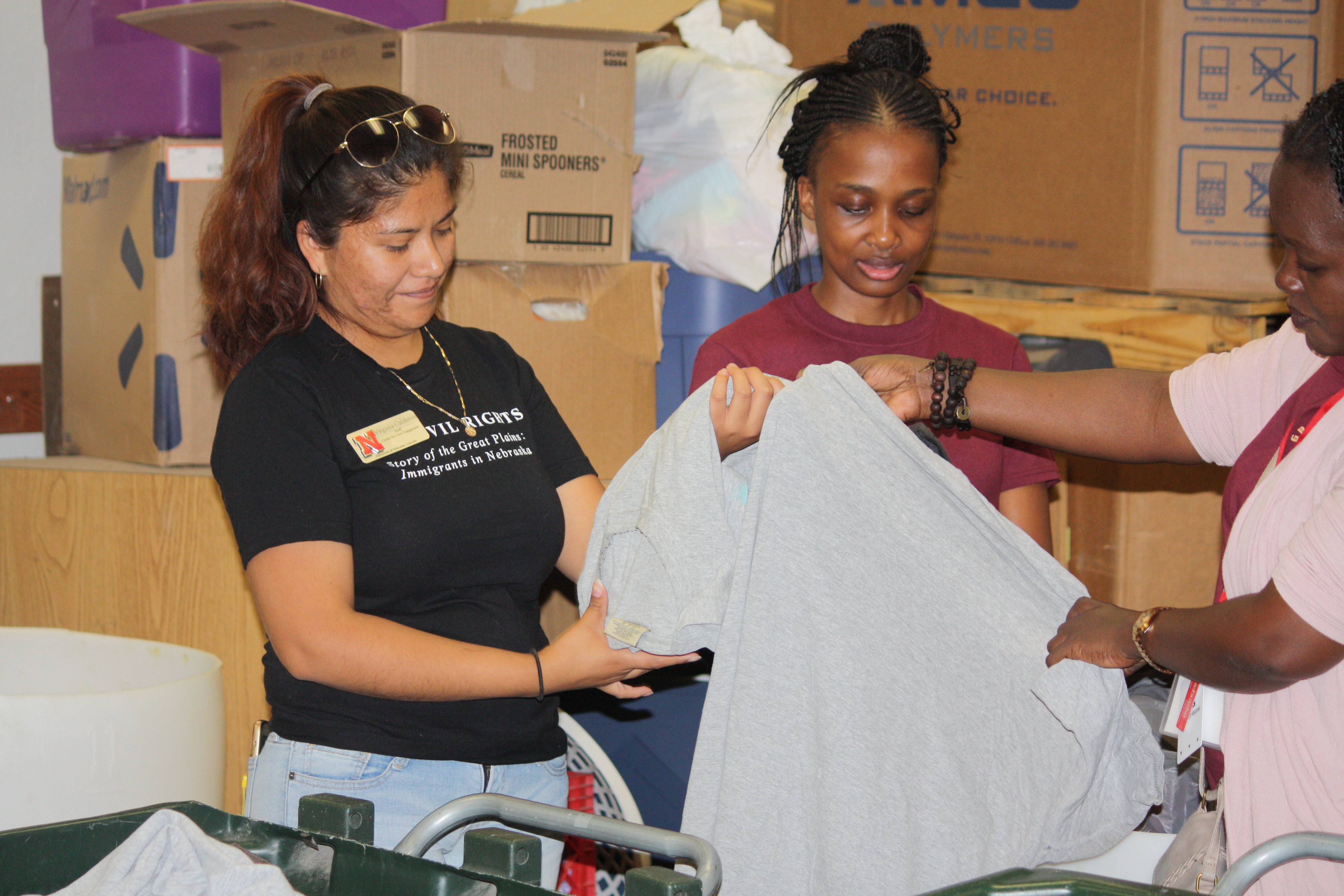 Volunteers with the Center for Civic Engagement assist the community by sorting clothing at a local thrift shop.