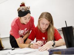 Taylor Hickey, freshman from Elwood, Nebraska, works with Kaelyn Tejral, freshman from Lincoln, during CALC106 recitation taught by Justin Nguyen in Pound Hall 105. At left is Leavitt Reno, freshman from Grand Island. | Craig Chandler, University Communic