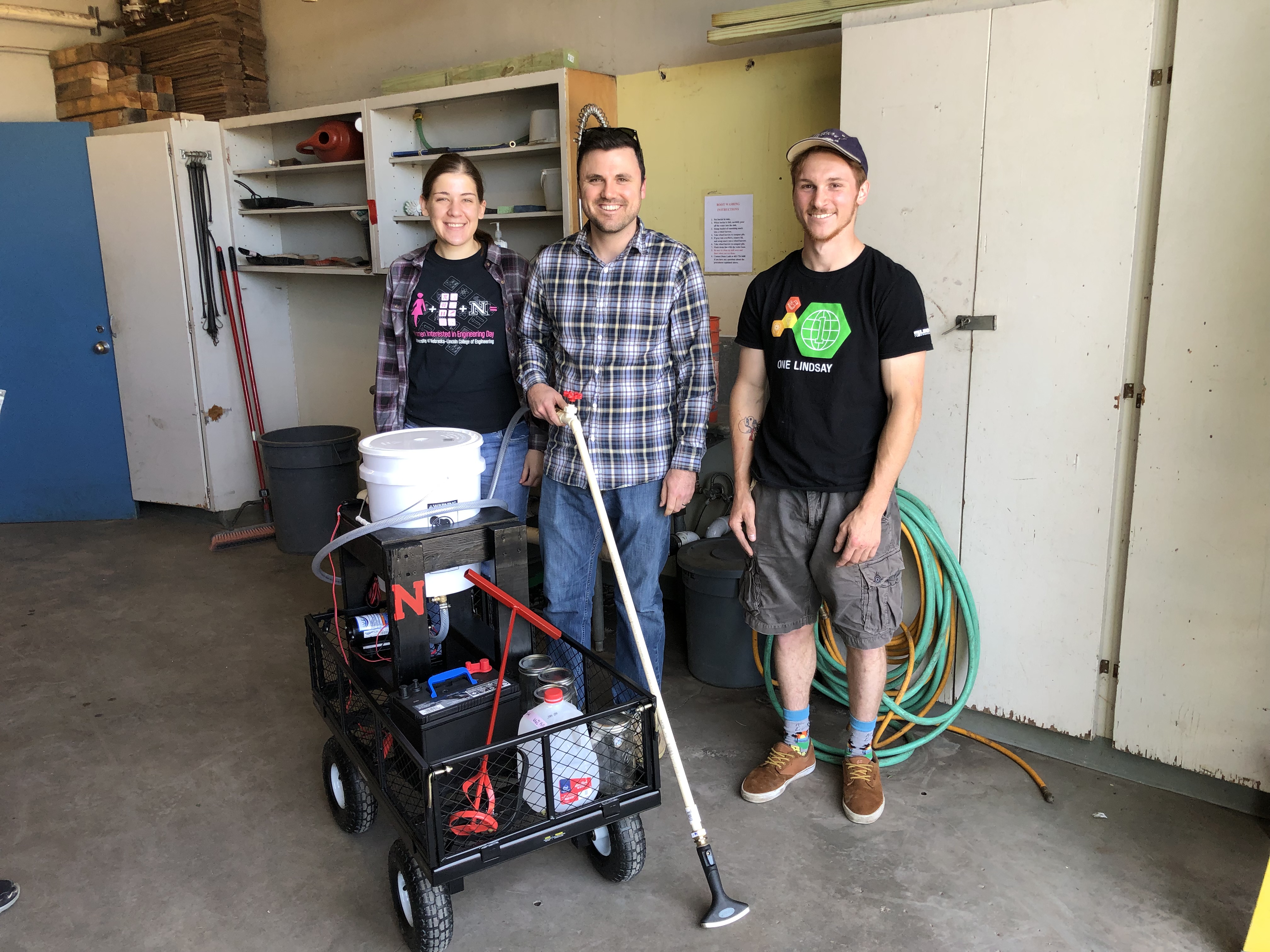 Kelsey Bohling (left) and Dalton Dozier (right) deliver their prototype biofilm application system to their client, Dr. Sam Wortman.