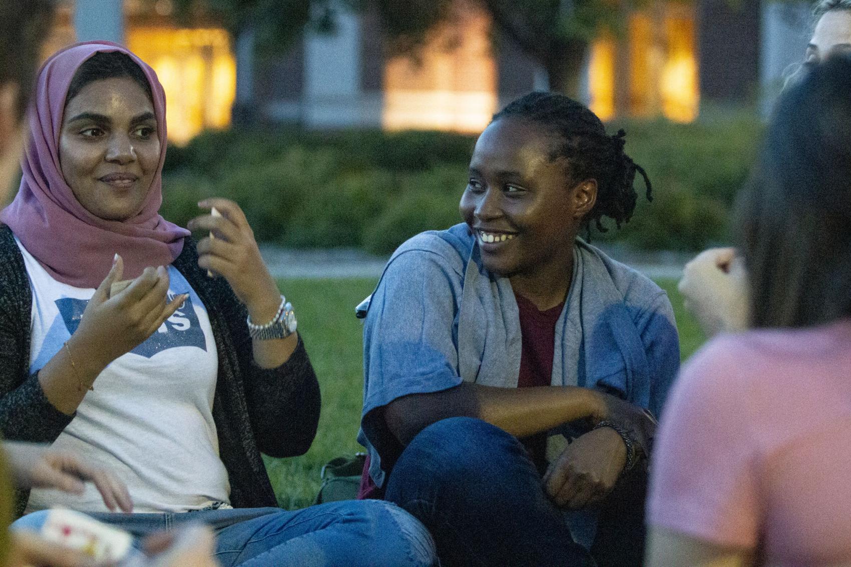 Julienne Irihose (right) reacts to Sara Alhuraizi (left) at the International Club meeting on the green space in front of the Union on University of Nebraska-Lincoln's city campus. Photo: The Daily Nebraskan.