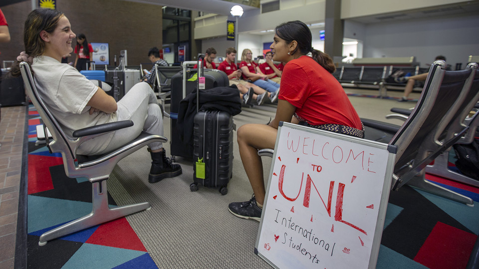 Shridula Hegde (right) talks with Katie Brooks during international student welcome activities on Aug. 19 at the Lincoln Airport. Photo: University Communications.