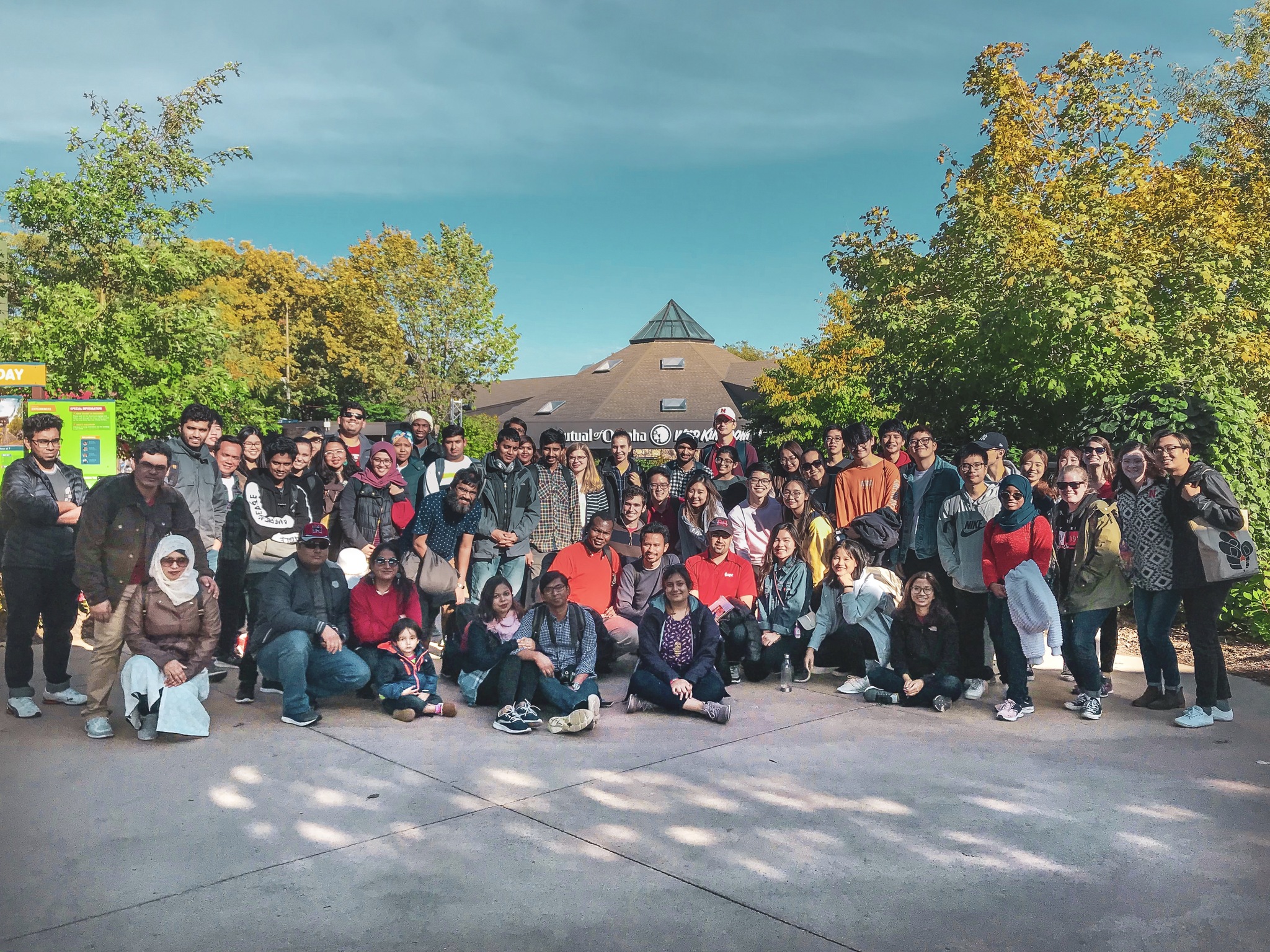 International students and scholars pose for a group photo at the Omaha Henry Doorly Zoo visit that include 115 participants, hosted by ISSO in October.