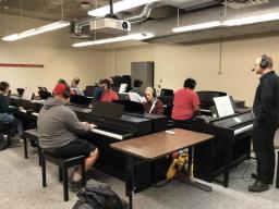 Students take part in a skills class in the large piano lab in Westbrook.