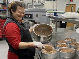 Diemhong "Hong" Tran prepares to bake eight mocha chocolate cheesecakes at Cather Dining Center on Nov. 13. Tran is the desserts team leader for University Dining Services and is instrumental in creating desserts from scratch across campus.