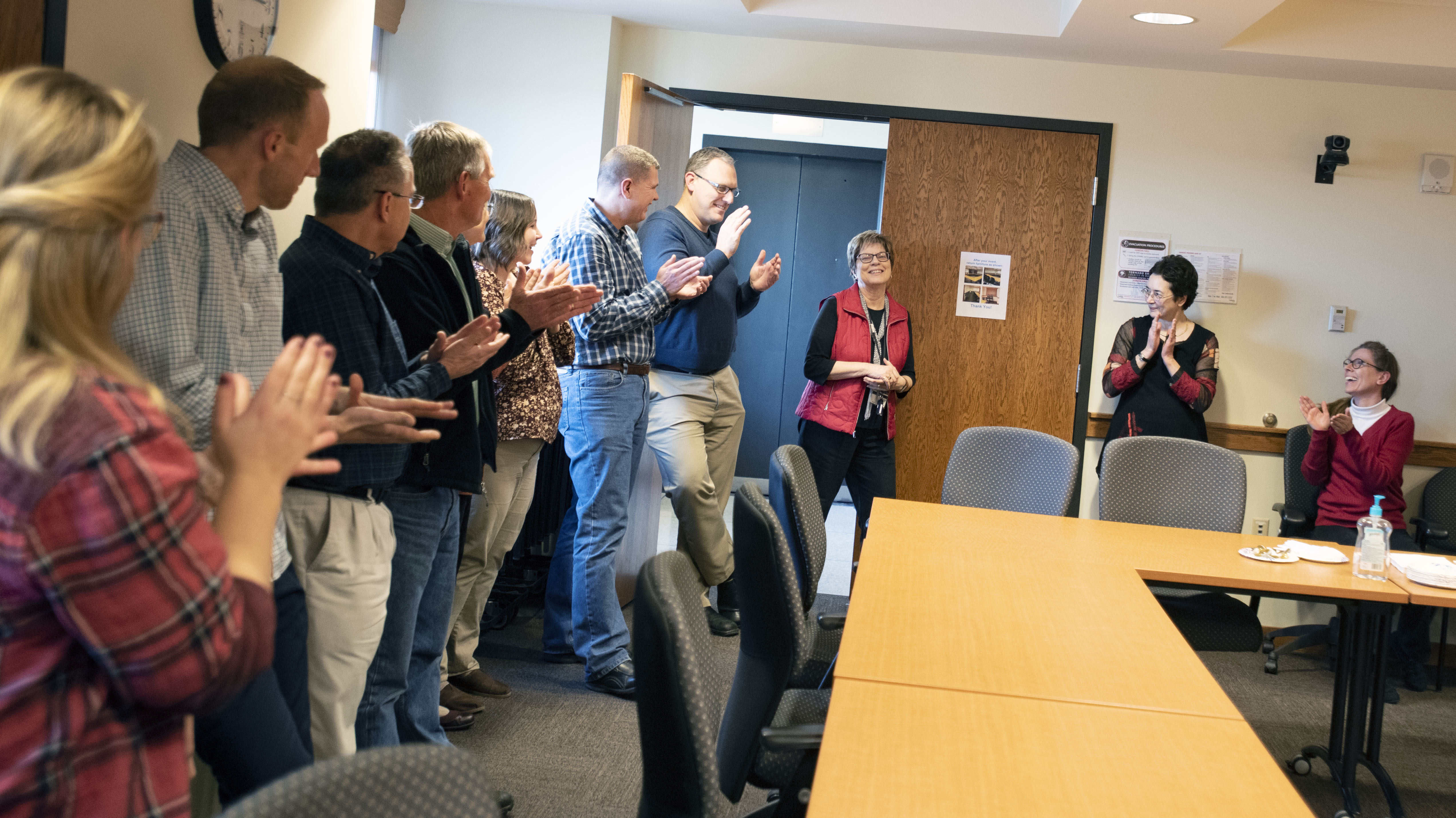 The NDMC staff gives Ann Fiedler a round of applause during her surprise retirement reception in Dec. 19, 2019, in Hardin Hall. | Shawna Richter-Ryerson