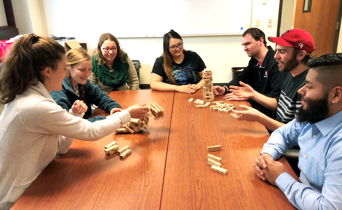 CRE students number the blocks in the game Jenga and play it with special rules to teach resilience concepts. Pictured are, from left, Julie Fowler, Jessica Johnson, Alison Ludwig, Rubi Quiñones, Conor Barnes, Dominic Cristiano and Daniel Morales.