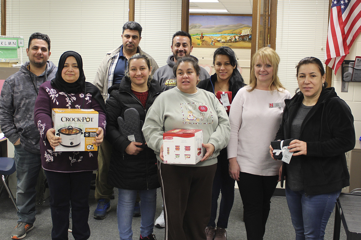 NEP staff member Dana Hardy (second from right) with an English Language Learner class after they received cookware items.